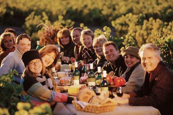 Group_of_people_sitting_at_table_outdoors_on_Qubecs_gourmet_dining_route_329526