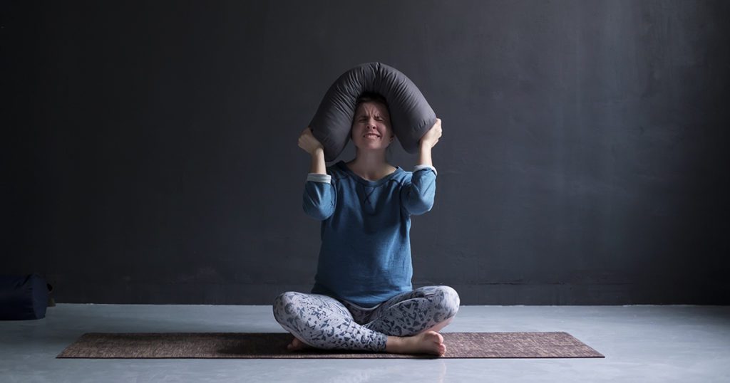 Frustrated woman alone on a yoga mat