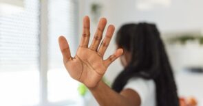 Photo of a woman's outstretched palm, signaling that she is saying, "no way" to something someone asked of her.